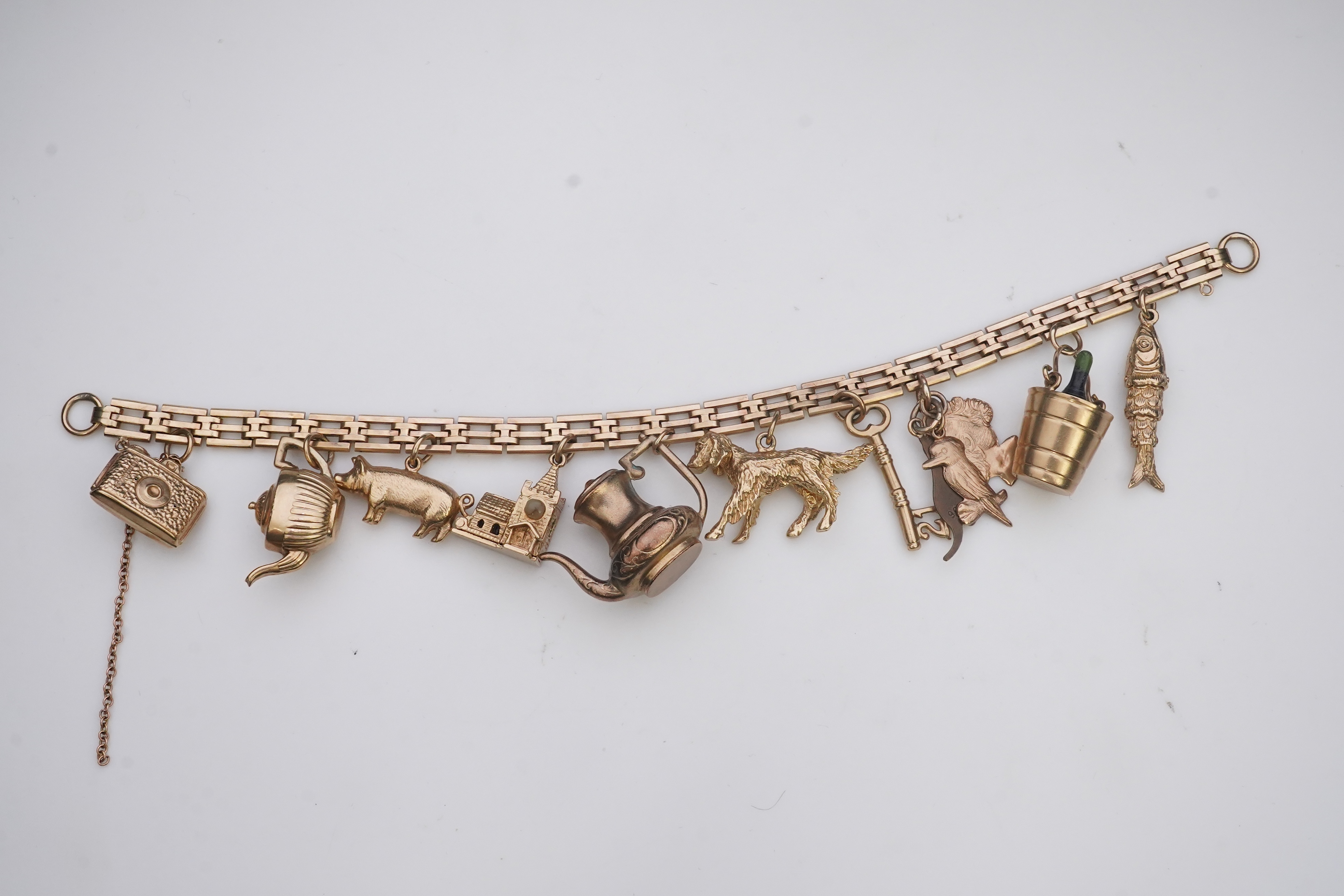 A charm bracelet, mid 20th century